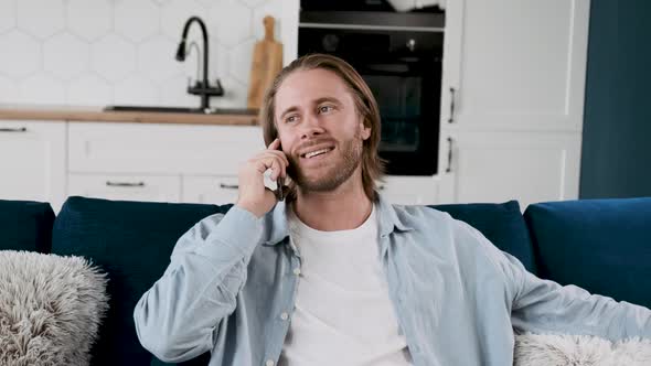 A Closeup Portrait of a Man Talking on the Phone Noding Smiling in a Relaxed Manner