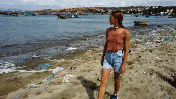 Slim Woman Looking In The Coast Of Mui Ne While Walking At Beach With Garbage In Vietnam. - aerial p