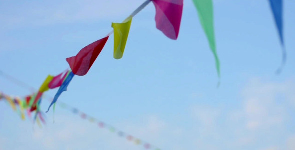 Multicolored striped triangular flags on a rope