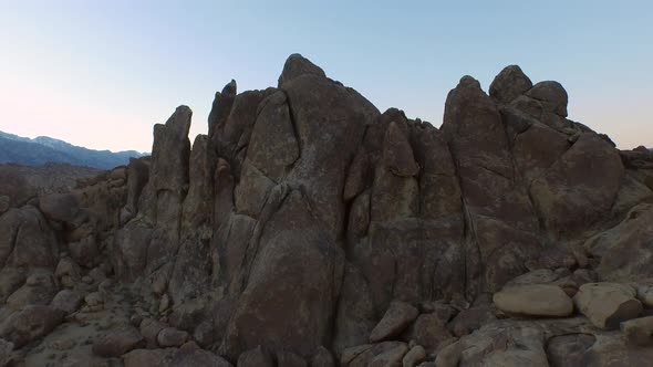 Aerial shot of a young man backpacker camping with his dog in a mountainous desert