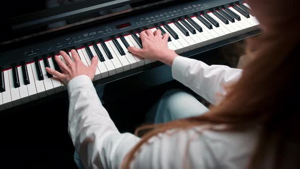 Close-up: a woman sensually plays the piano