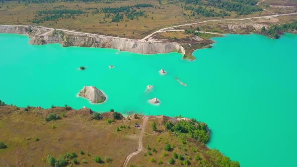 An artificial lake in chalk quarry. view from drone. Turquoise water background