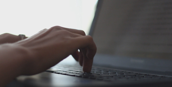 Office Worker Typing on Laptop