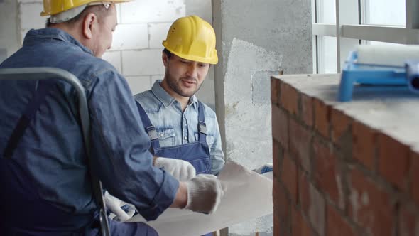 Workmen Discussing Blueprint