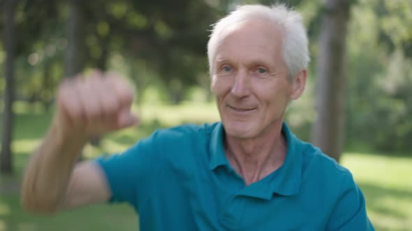 Portrait of Joyful Senior Sportsman Boxing Shadow in Slow Motion Smiling