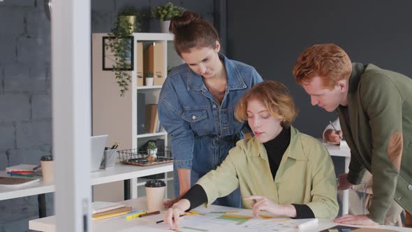 Young Businesswoman Sharing Ideas with Coworkers