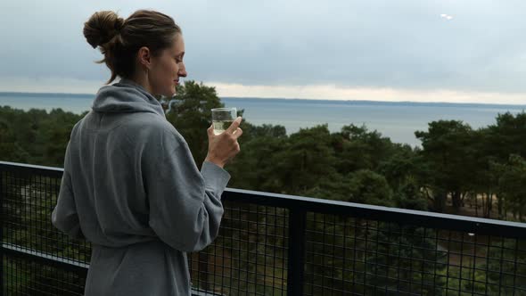 Beautiful Lady Enjoying Sea View From the Balcony