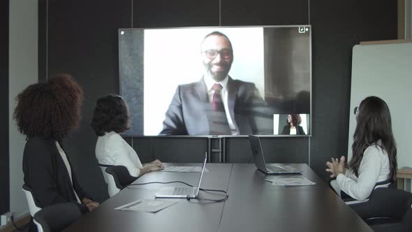 Business Partners Greeting and Waving During Video Chat