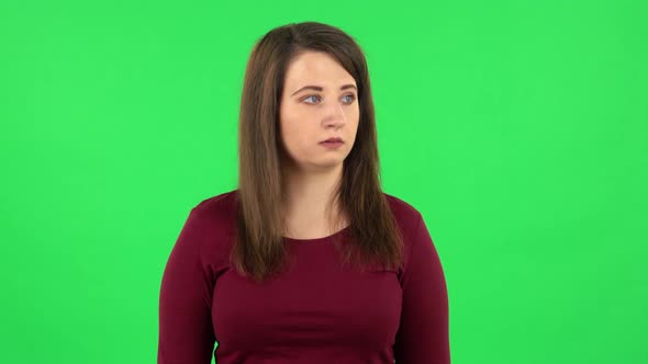 Portrait of Pretty Girl Is Scared, Then Smiles and Sighs in Relief. Green Screen