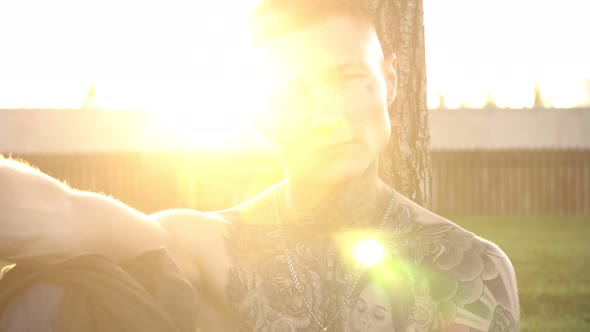 Portrait of a Young Attractive Man with Beautiful Tattoos on His Chest, Face and Neck