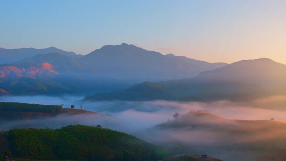 4K : Colorful sunrise over mountains tops in thailand