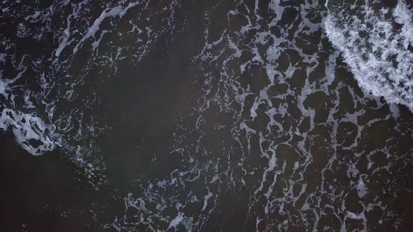 Aerial view of waves crashing into each other