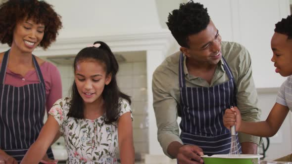 African american family baking together in the kitchen at home