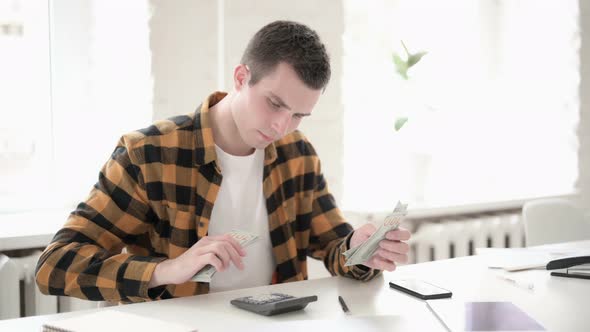 Casual Young Man Calculating Finance, Counting Dollar