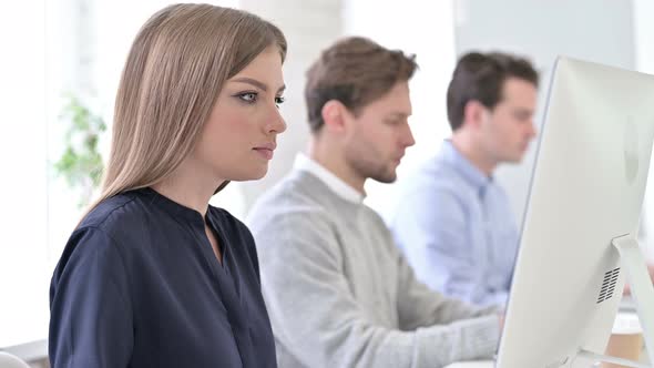 Creative Professionals Using Laptops in Office