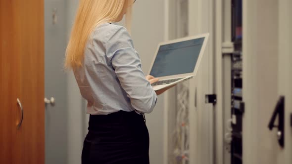 Woman It Engineer Working In Server Room. Network Engineer Work In Data Center.IT Technician Work.