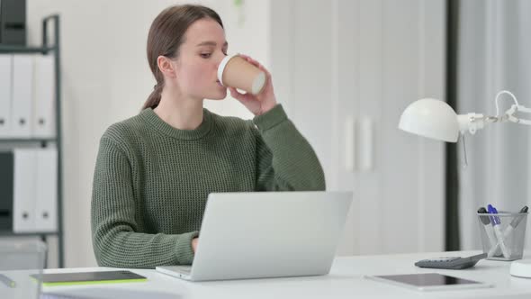 Young Woman Drinking Coffee at Work and Having Toothache 