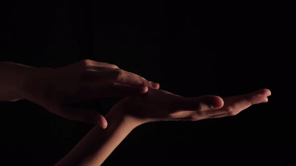 Female Hands On A Black Background