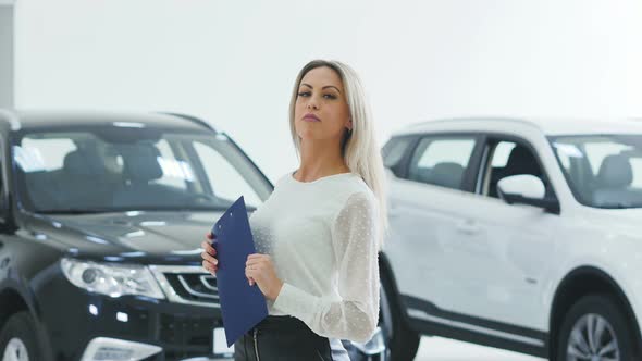 Young Woman Car Shop Manager With Paperboard