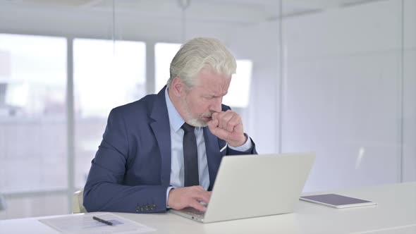 Coughing Sick Old Businessman Working on Laptop