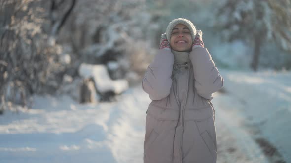 Joyful Beautiful Woman Walking Outdoors in Frosty Park After Snowfall