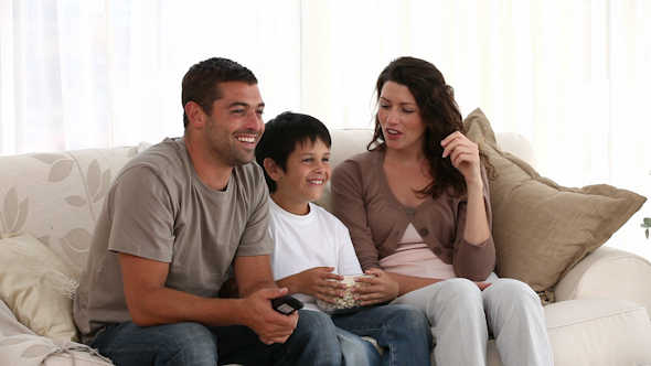 Family Watching Television on The Sofa