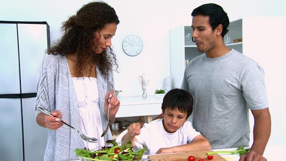 Woman Cooking a Salad With Her Son