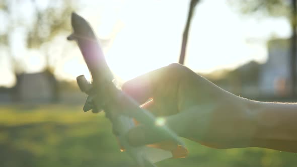 Model Toy Airplane in Hands Flying in Air, the Concept of Travel and the Lifting of Quarantine, Slow