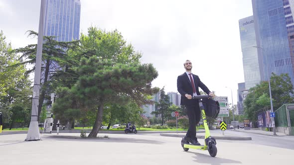 Businessman driving electric scooter.