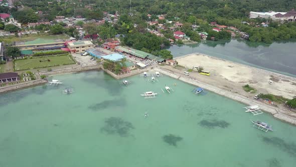 Beautiful aerial view of the coastal town Moalboal from a drone slowly descending over Badian Bay in