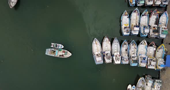 Top View at Colorful Boats on Sea Surface Near Concrete Pier