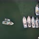 Top View at Colorful Boats on Sea Surface Near Concrete Pier - VideoHive Item for Sale