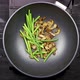 Pouring Soy Sauce on Mushrooms and Garlic Sprouts that are Fried on a Wok Skillet - VideoHive Item for Sale