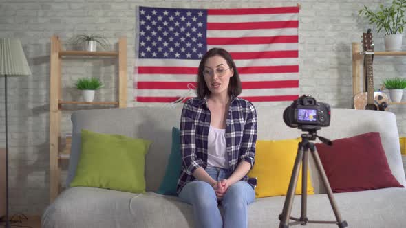 Portrait Oung Woman Blogger in Shirt on American Flag Background Recording Video