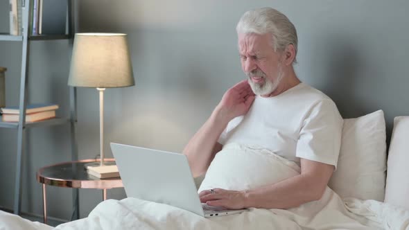 Laptop Work By Old Man with Neck Pain in Bed