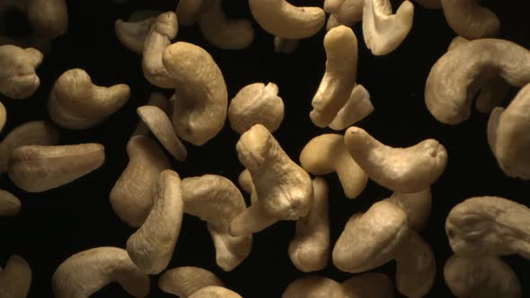 Cashew Nuts Flying In The Air In A Free Fall In Slow Motion On Black Background 4K