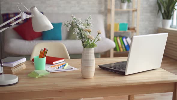 Vase with Flowers Stands on the Table in a Modern Apartment