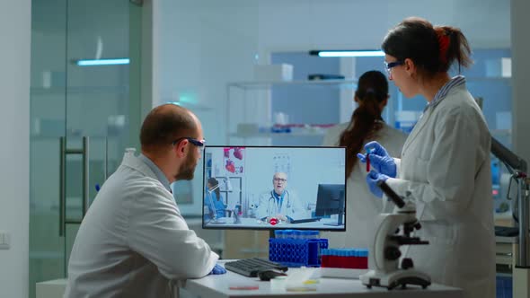 Team of Scientist Advicing with Professional Doctor on Video Call