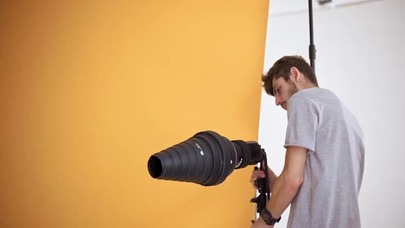 Handsome Young Man Getting Ready for Shooting Setting Lighting Equipment