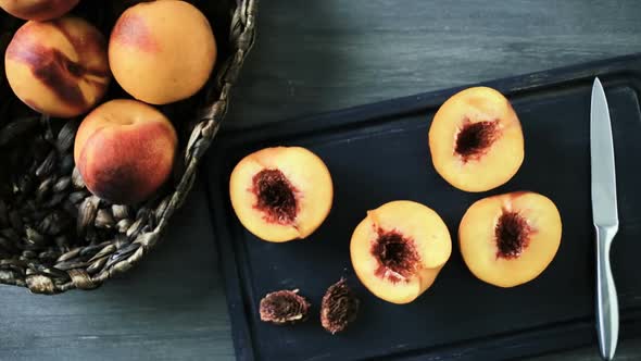 Cutting peaches in half for making grilled peaches.