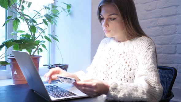 Female Using Bank Card for Online Payment in Office