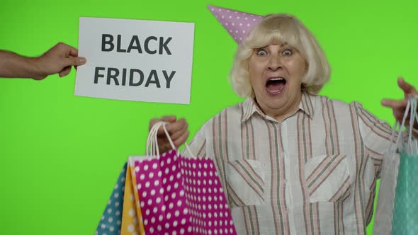 Advertisement Inscription Black Friday Appears Next To Joyful Grandmother with Shopping Bags