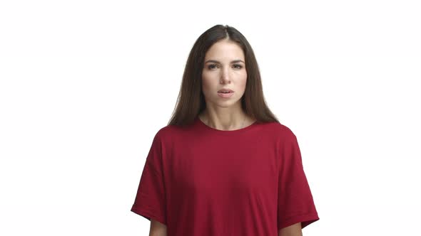 Attractive Brunette Woman in Red Tshirt Looking Disappointed Cross Arms on Chest and Shaking Head