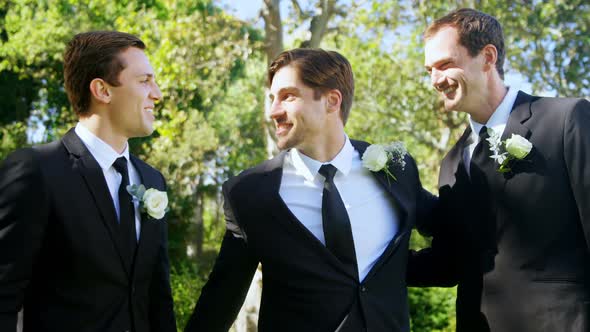 Three men are happy at wedding hugging each other 4K 4k