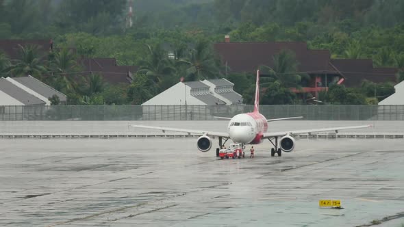 Airplane on the Airfield in the Rain