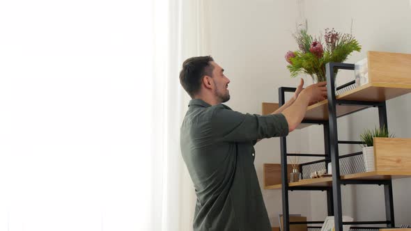 Man Decorating Home with Flower or Houseplant