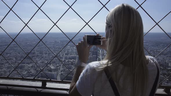 Woman Taking Photo of Cityscape with Smartphone