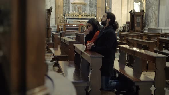 Couple praying in church. Christianity, hope, faith