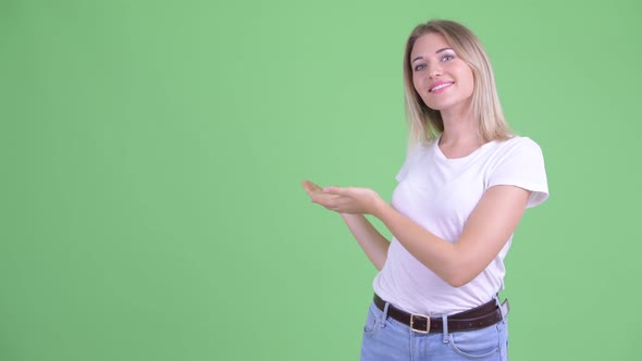 Happy Young Beautiful Blonde Woman Showing To the Back