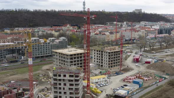 Construction site in Prague city with cranes and building material.
